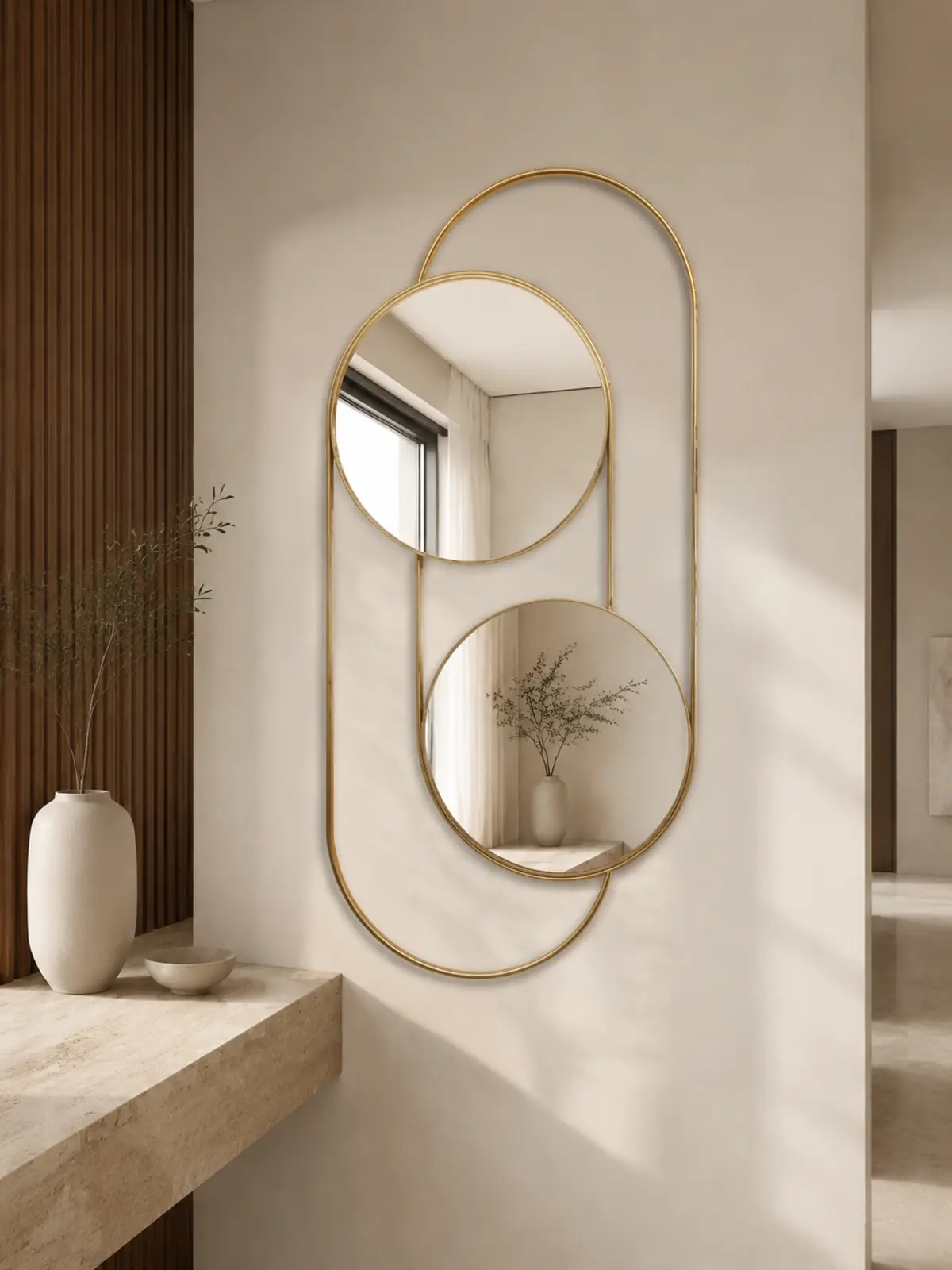 Orbit Duo wall mirror with two offset circular mirrors and a Gold PVD capsule frame